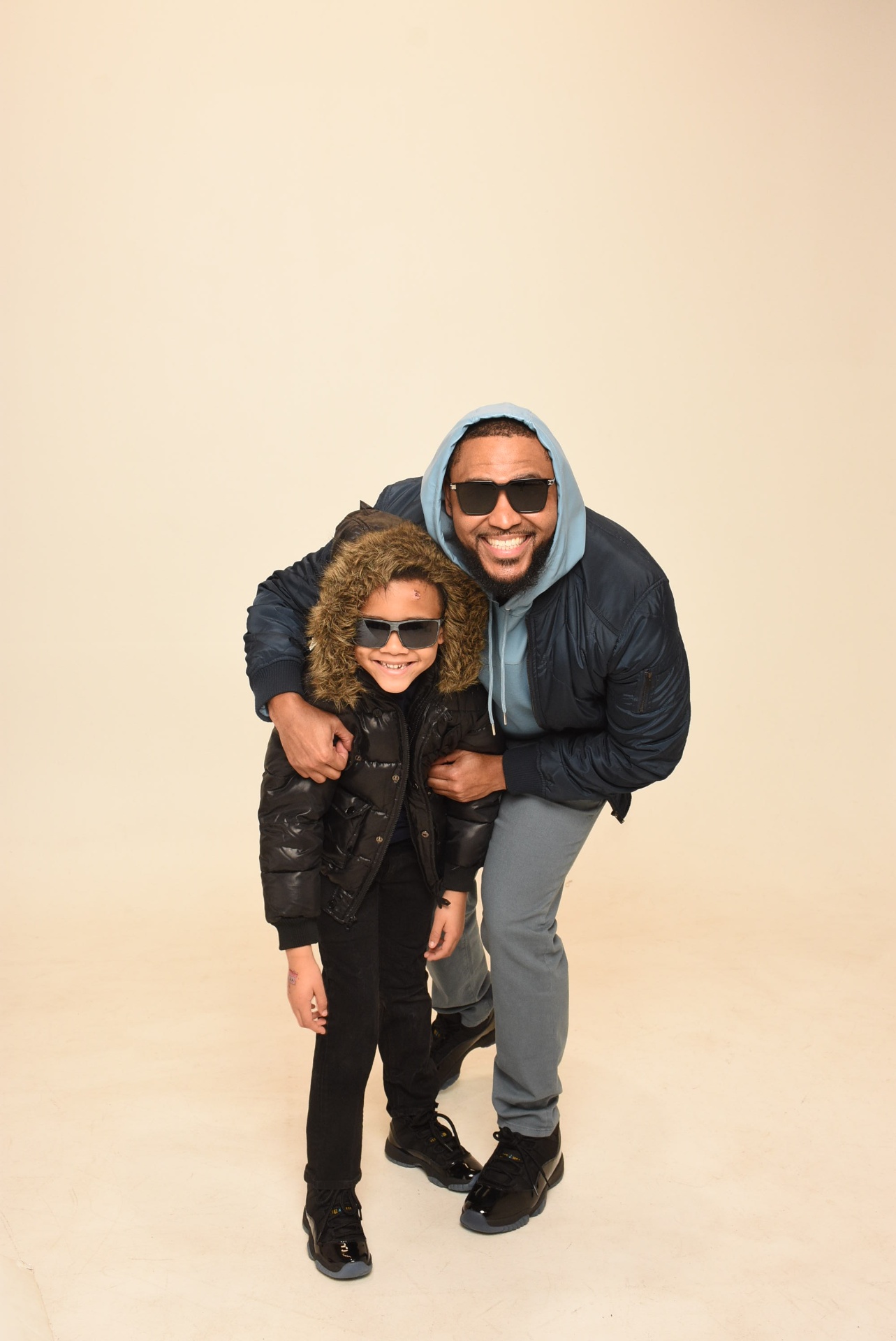 Father and son in matching outfits with sunglasses